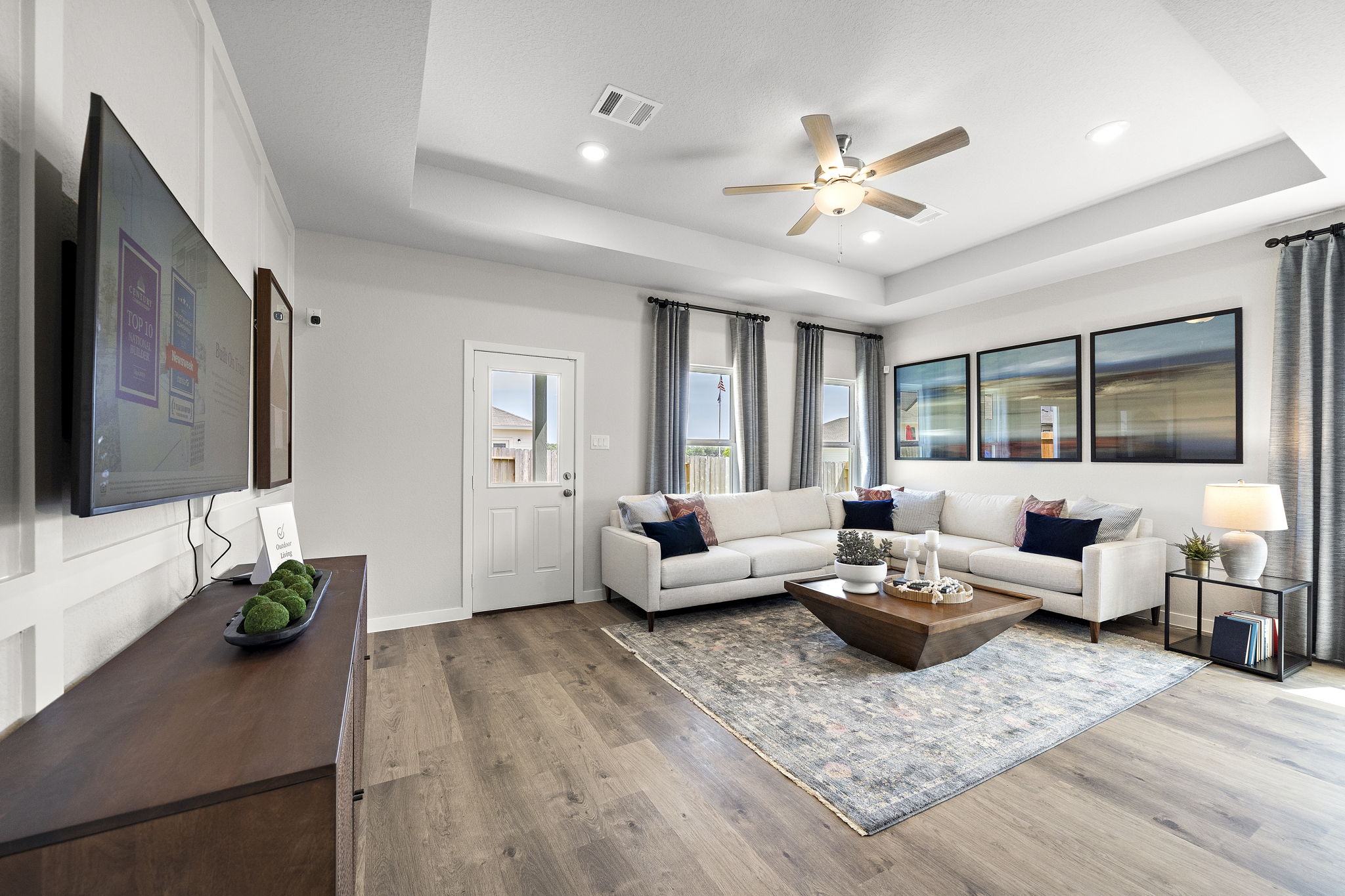 A living room with a large television and a couch.