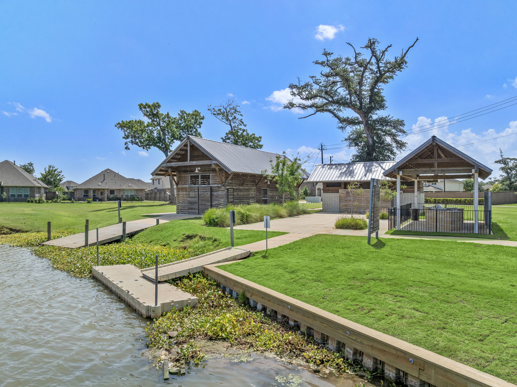 A small pond with a small building in the background.