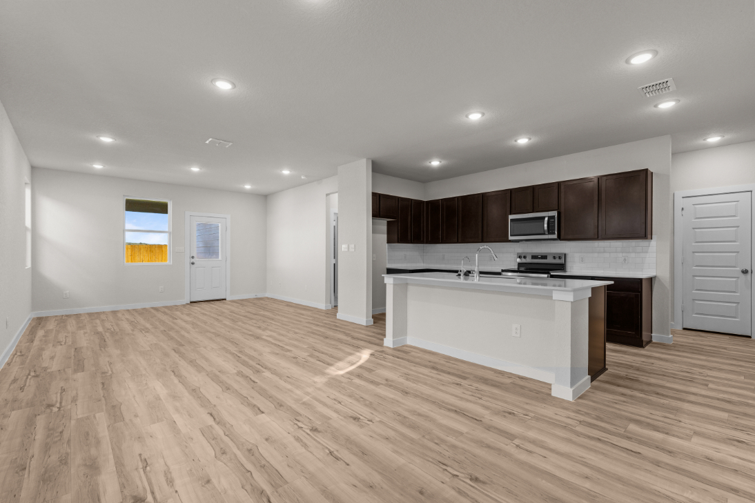 A large kitchen with wooden floors.