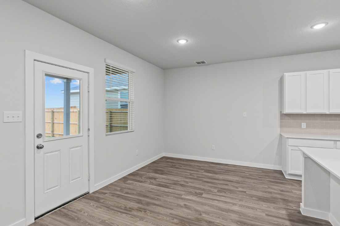 A room with white walls and a wood floor.
