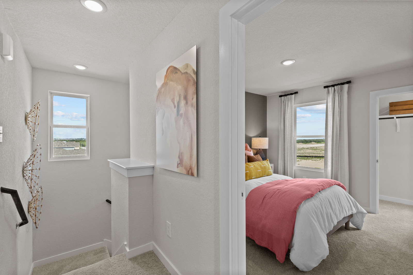 A bedroom with a bed and a painting on the wall.