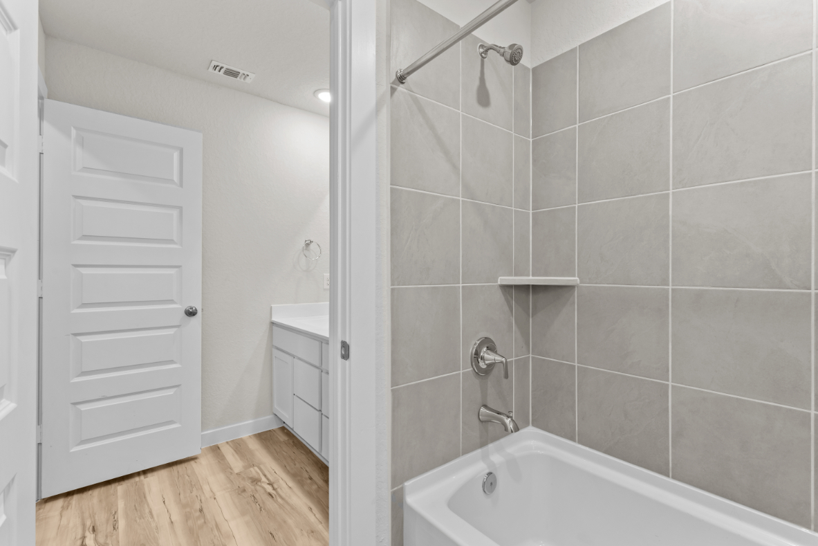 A bathroom with a shower and a bathtub.