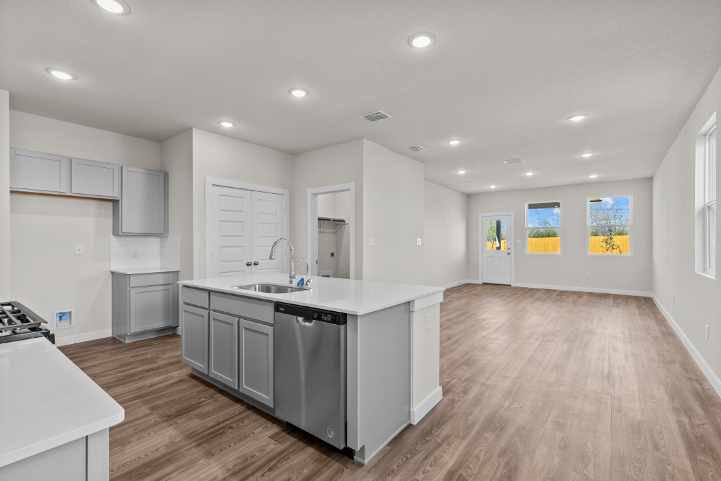 A kitchen with white cabinets.