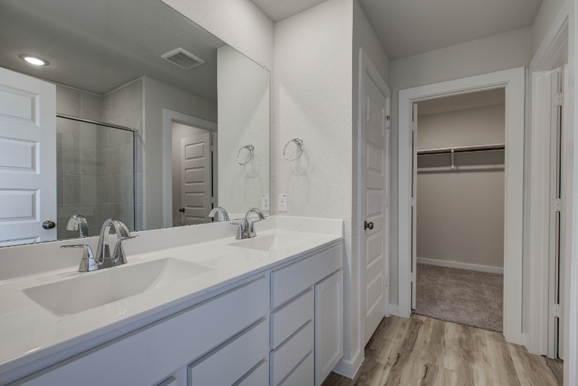 A bathroom with a large mirror.