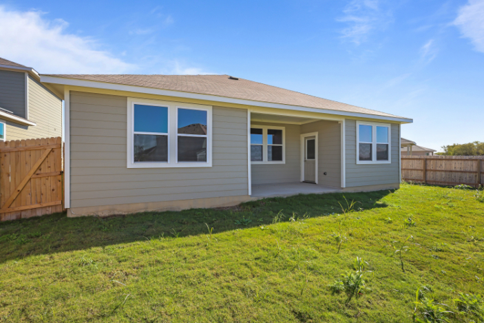 A house with a fence and grass.