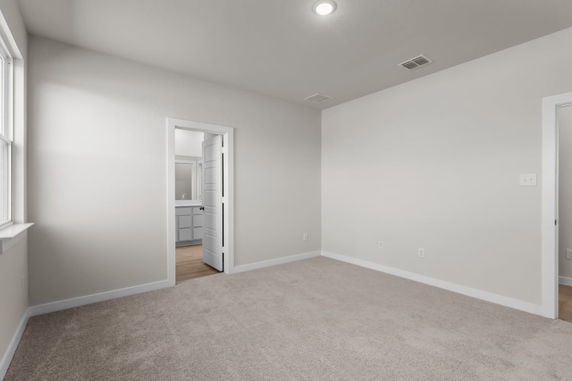 A room with a door and a mirror.