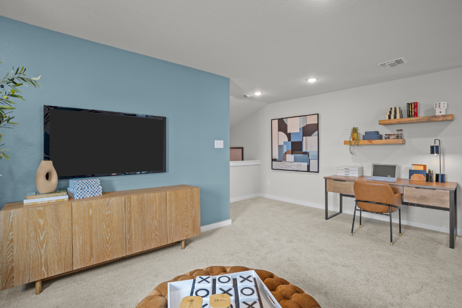 A room with a tv and a couch.