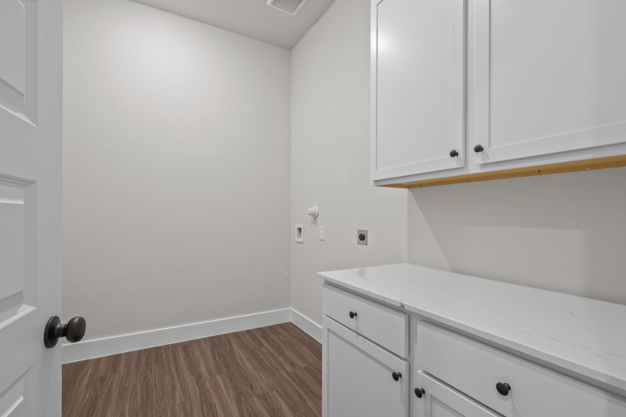 A white kitchen with white cabinets.