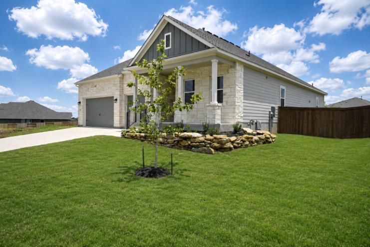 A house with a tree in the front yard.