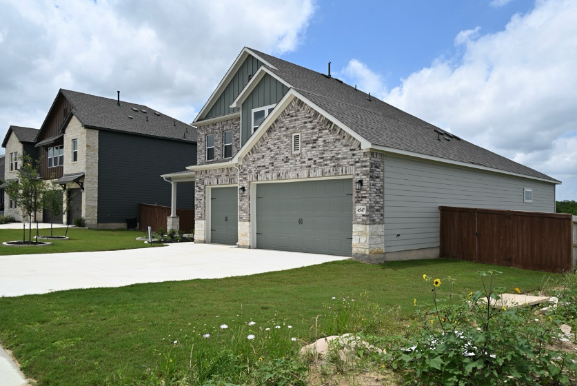 A house with garages and grass.