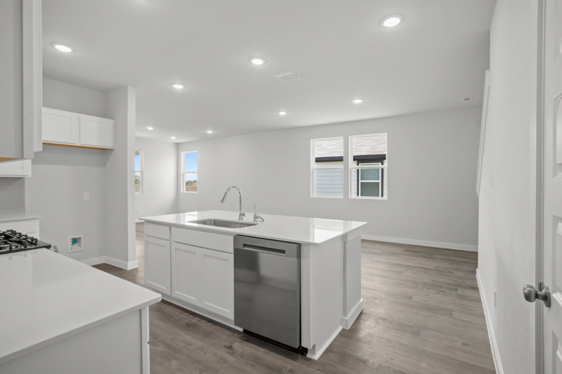 A kitchen with white cabinets.