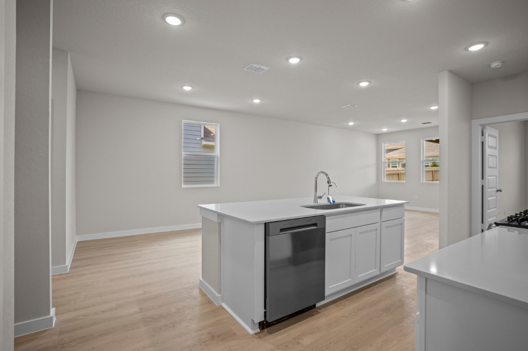 A kitchen with white cabinets.