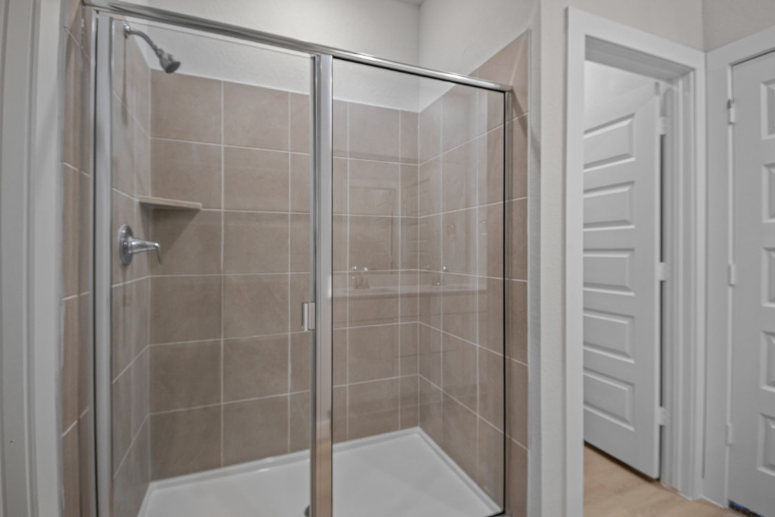 A shower with a glass door.