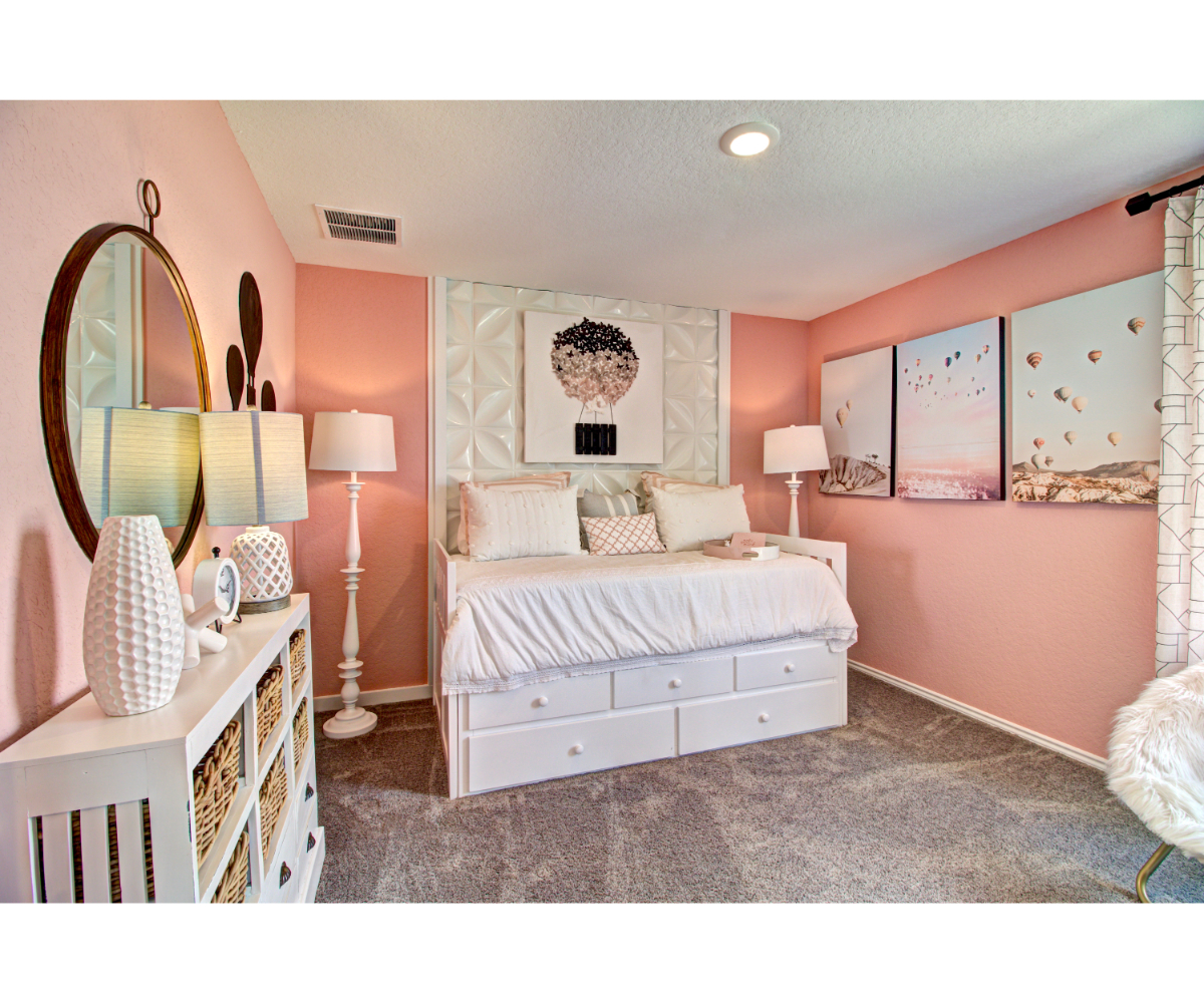 A bedroom with pink walls.