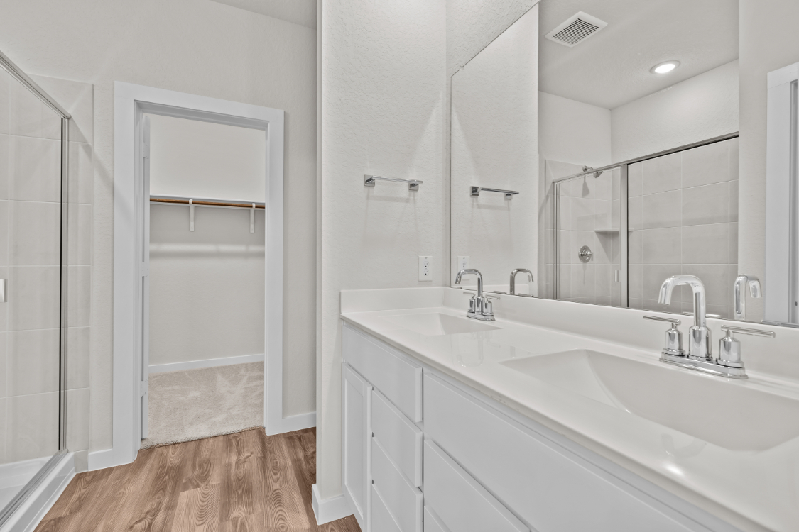 A bathroom with a tub sink and shower.
