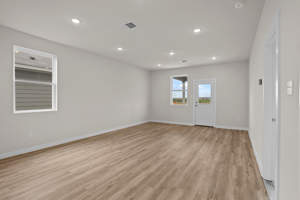 A room with a wood floor and white walls.