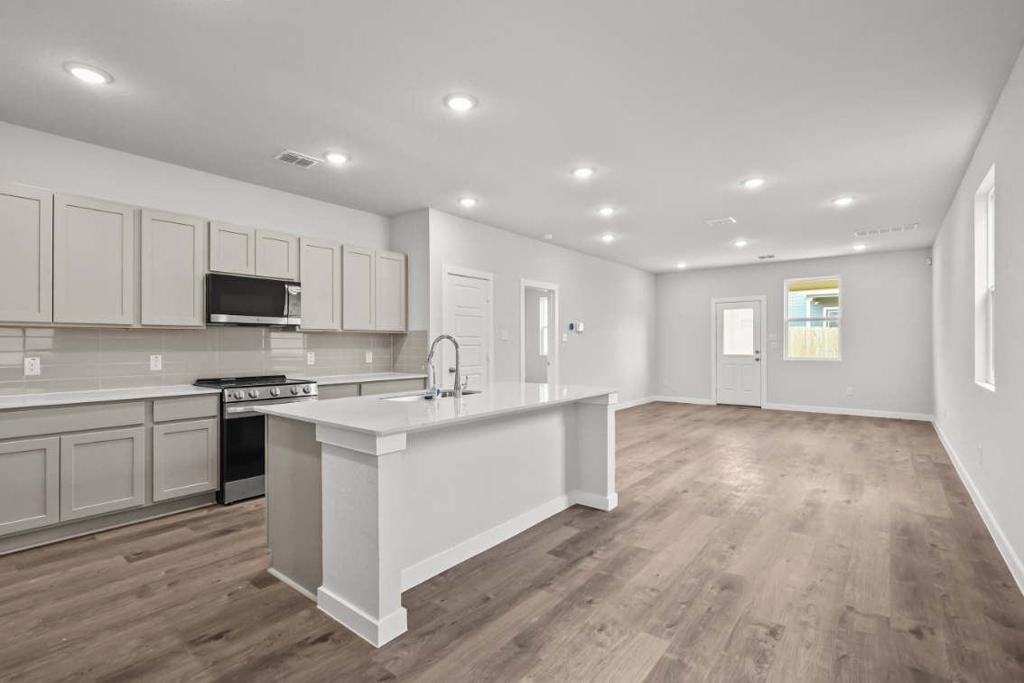 A kitchen with white cabinets.