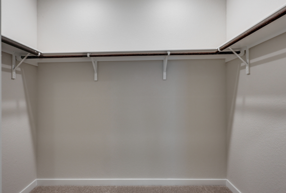A white wall with a metal bar.