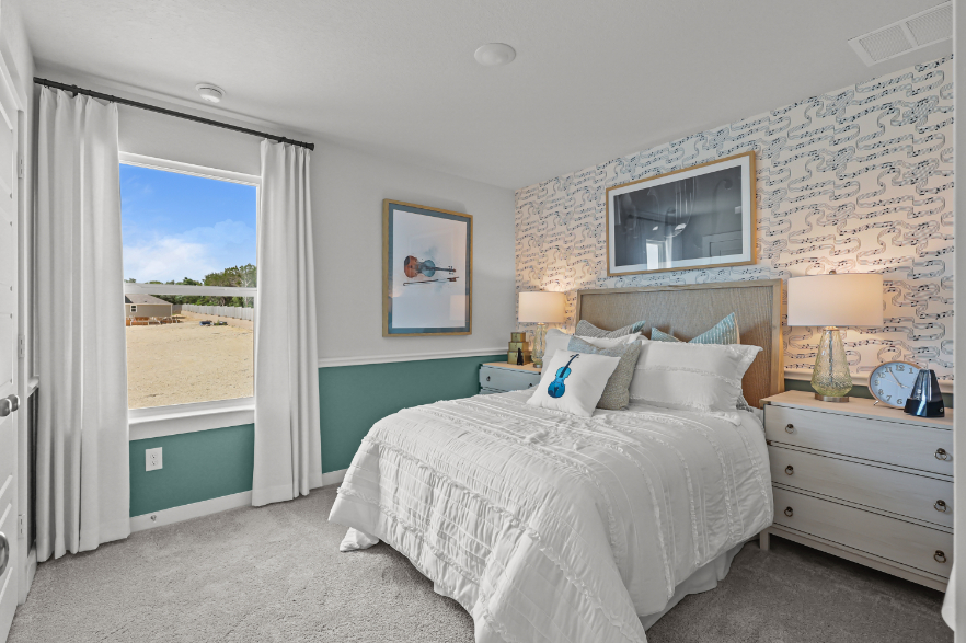 A bedroom with a large window.