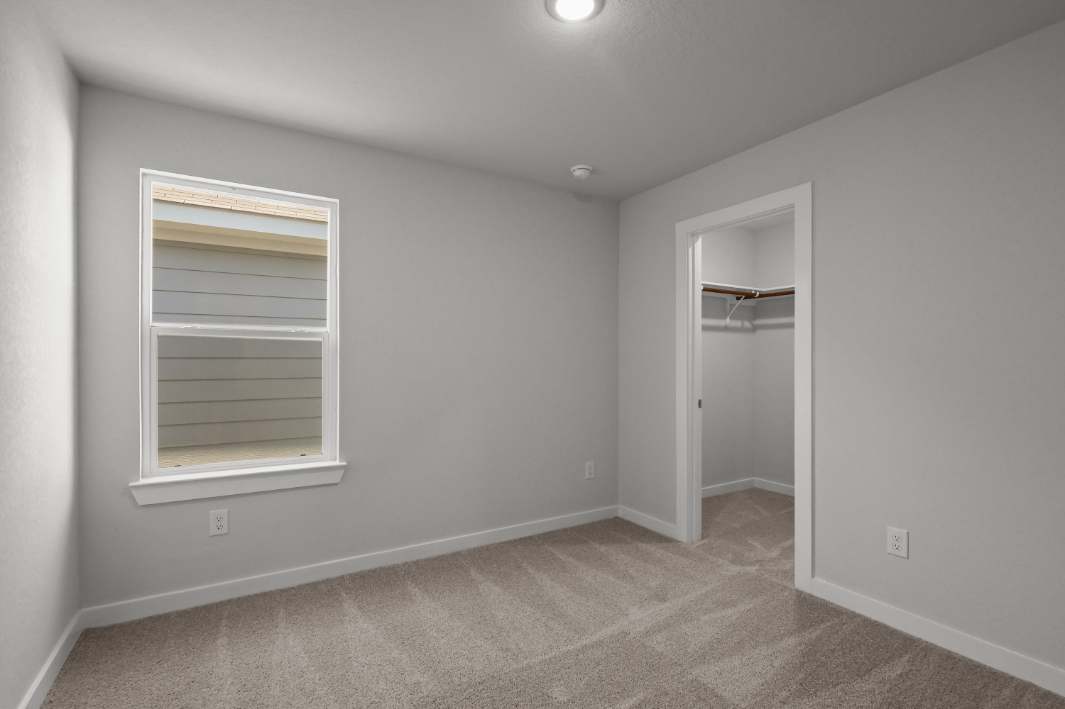 A room with a window and a door.