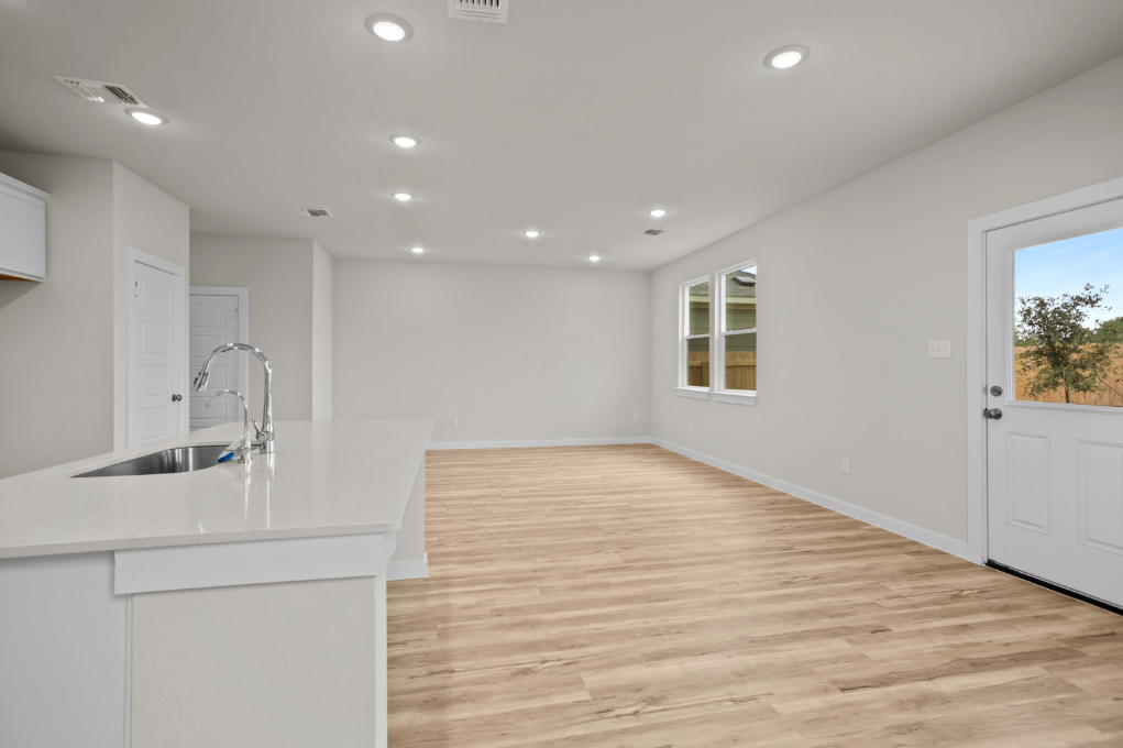 A kitchen with white cabinets.