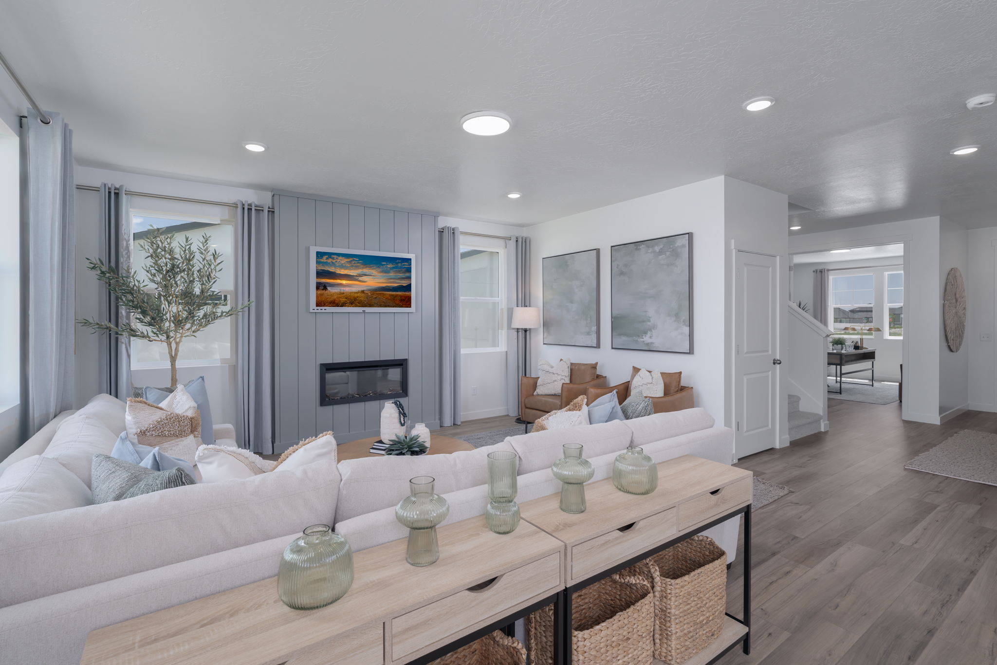 A living room with a large glass table and a large white couch.