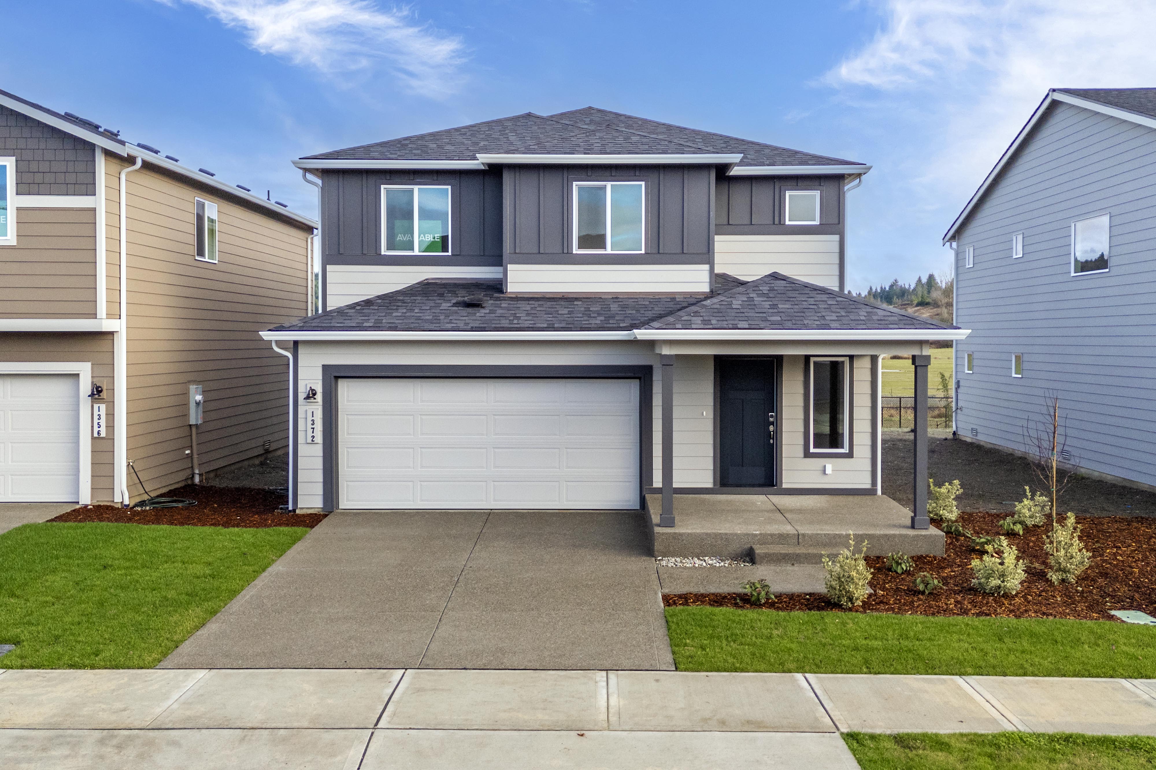 A house with garages and a driveway.