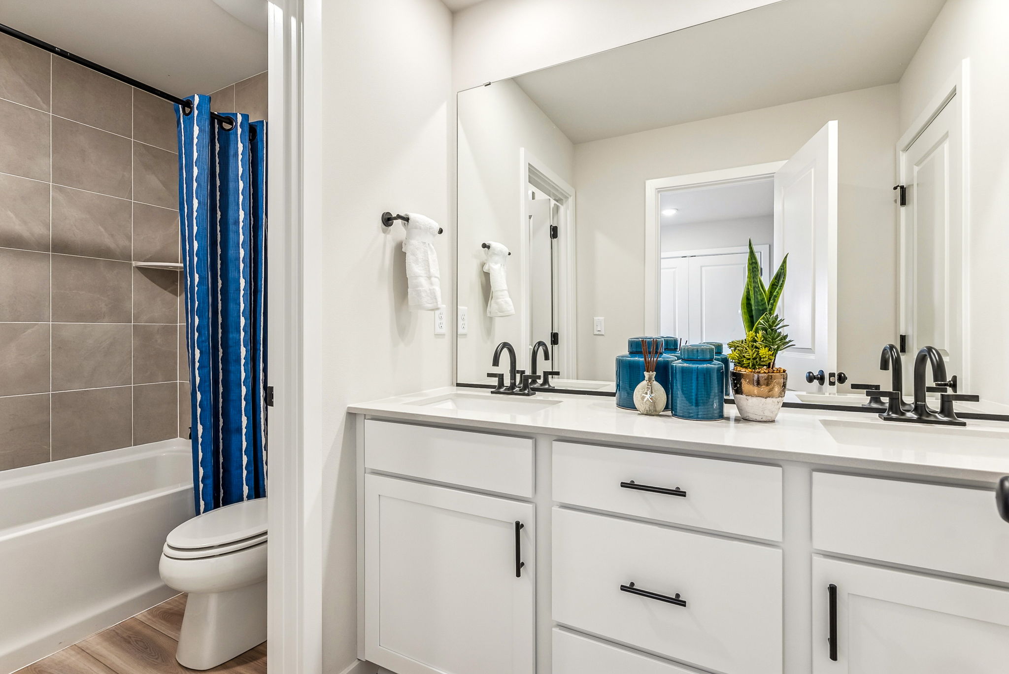 A bathroom with a tub sink and toilet.