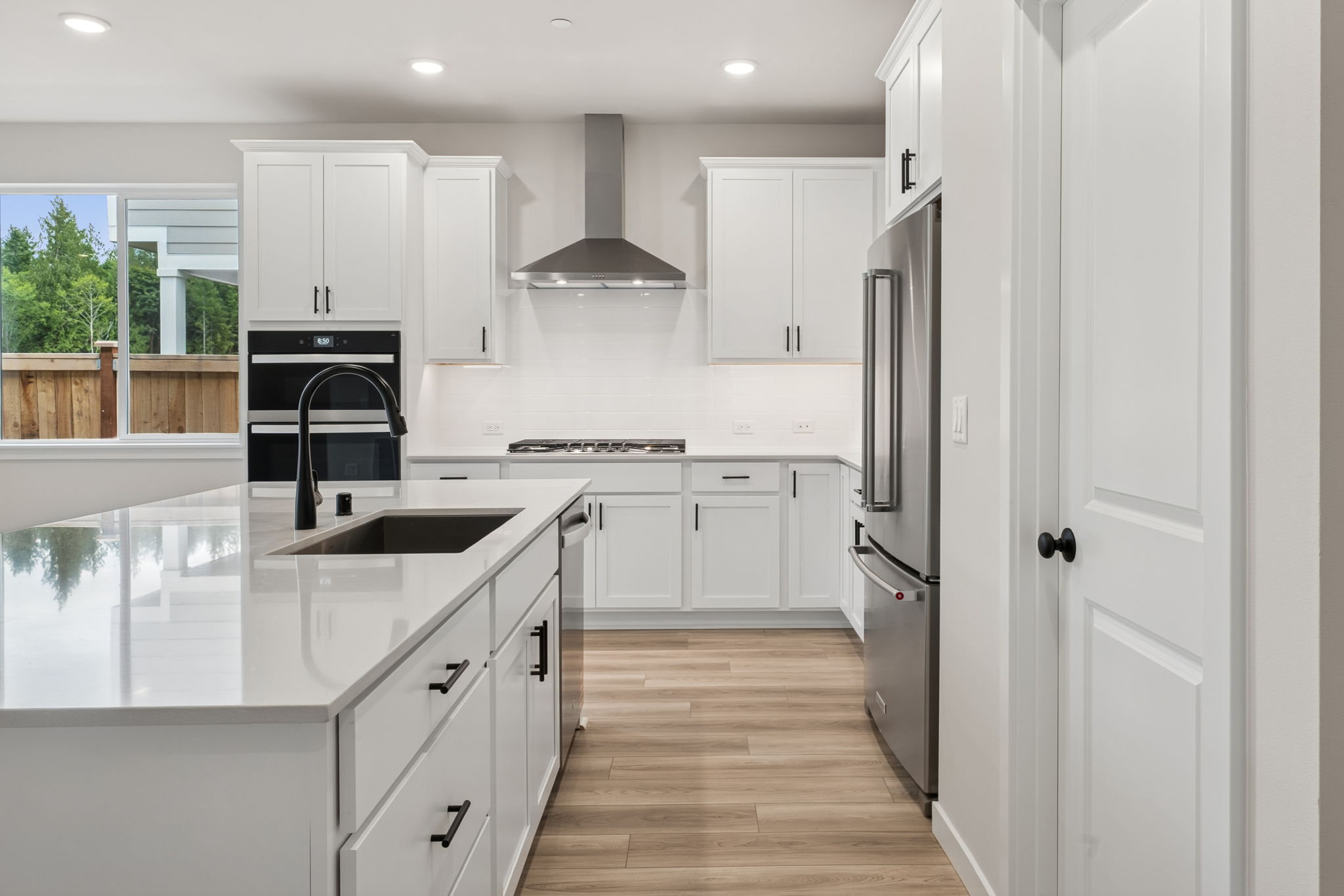 A kitchen with white cabinets.