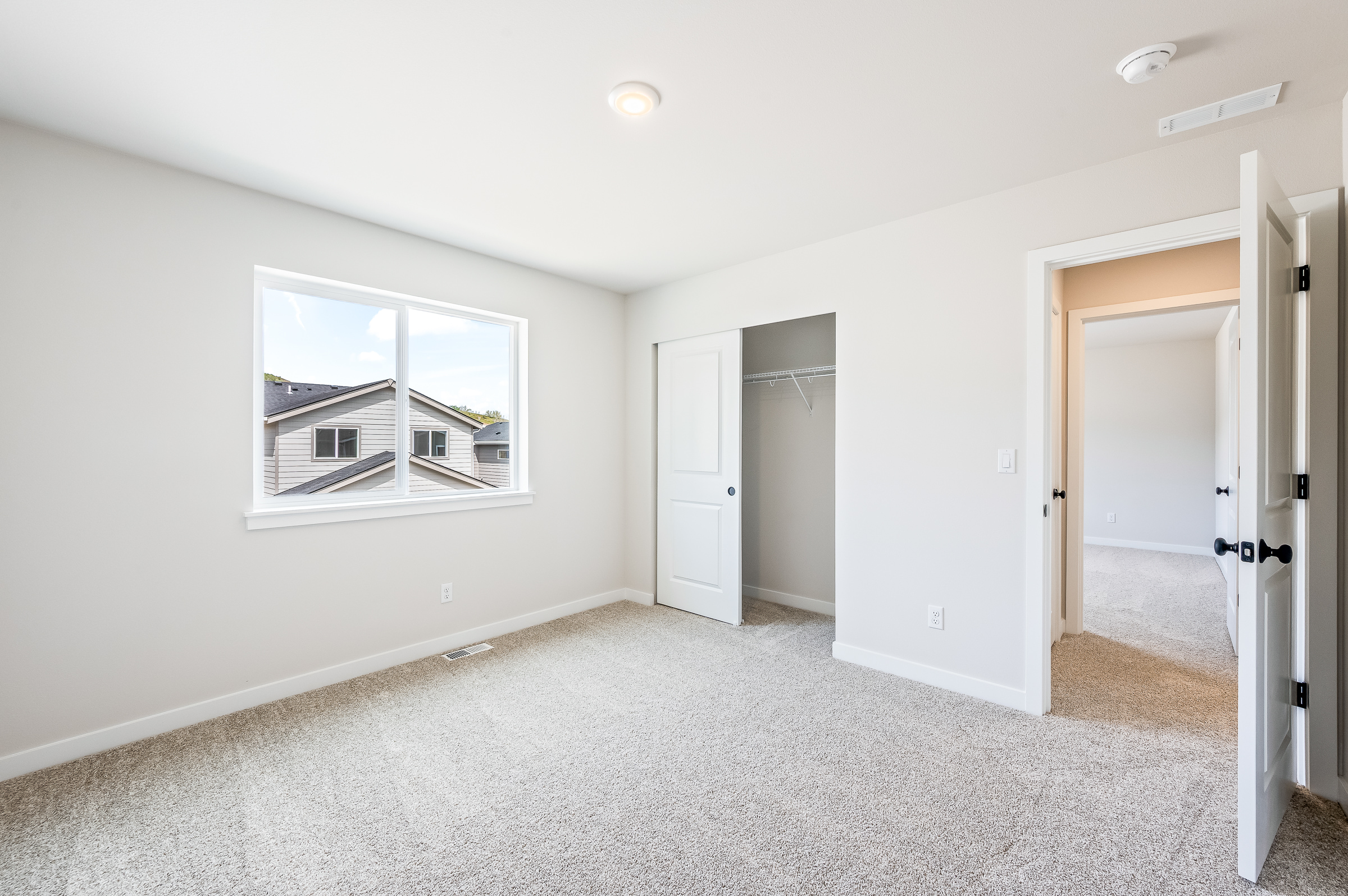 A room with white walls and a window.