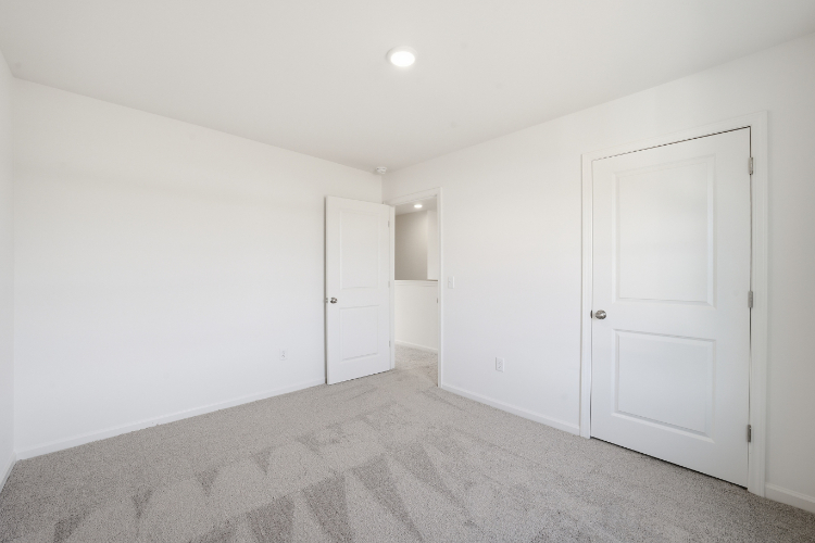 A hallway with white doors.