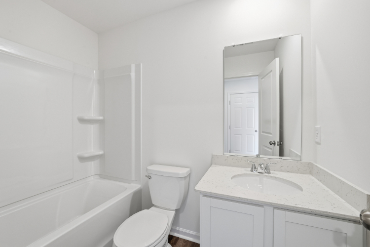 A bathroom with a sink toilet and bathtub.