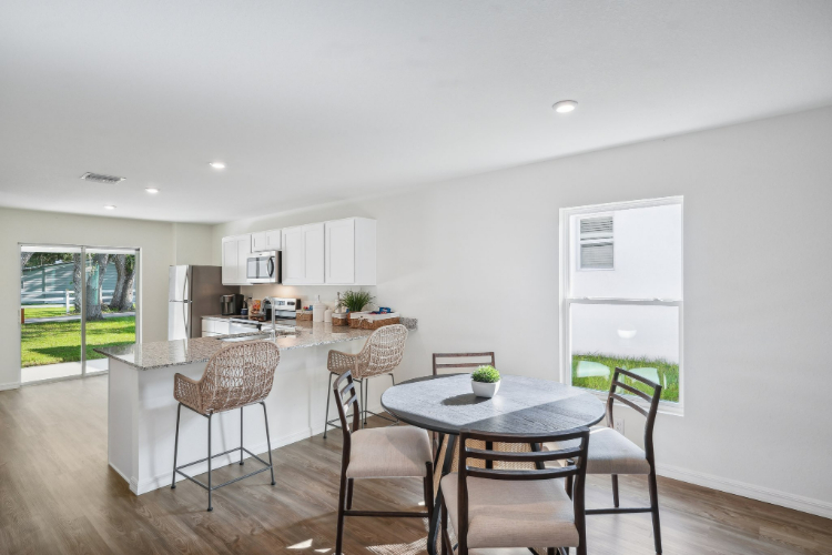 A kitchen with a dining table.