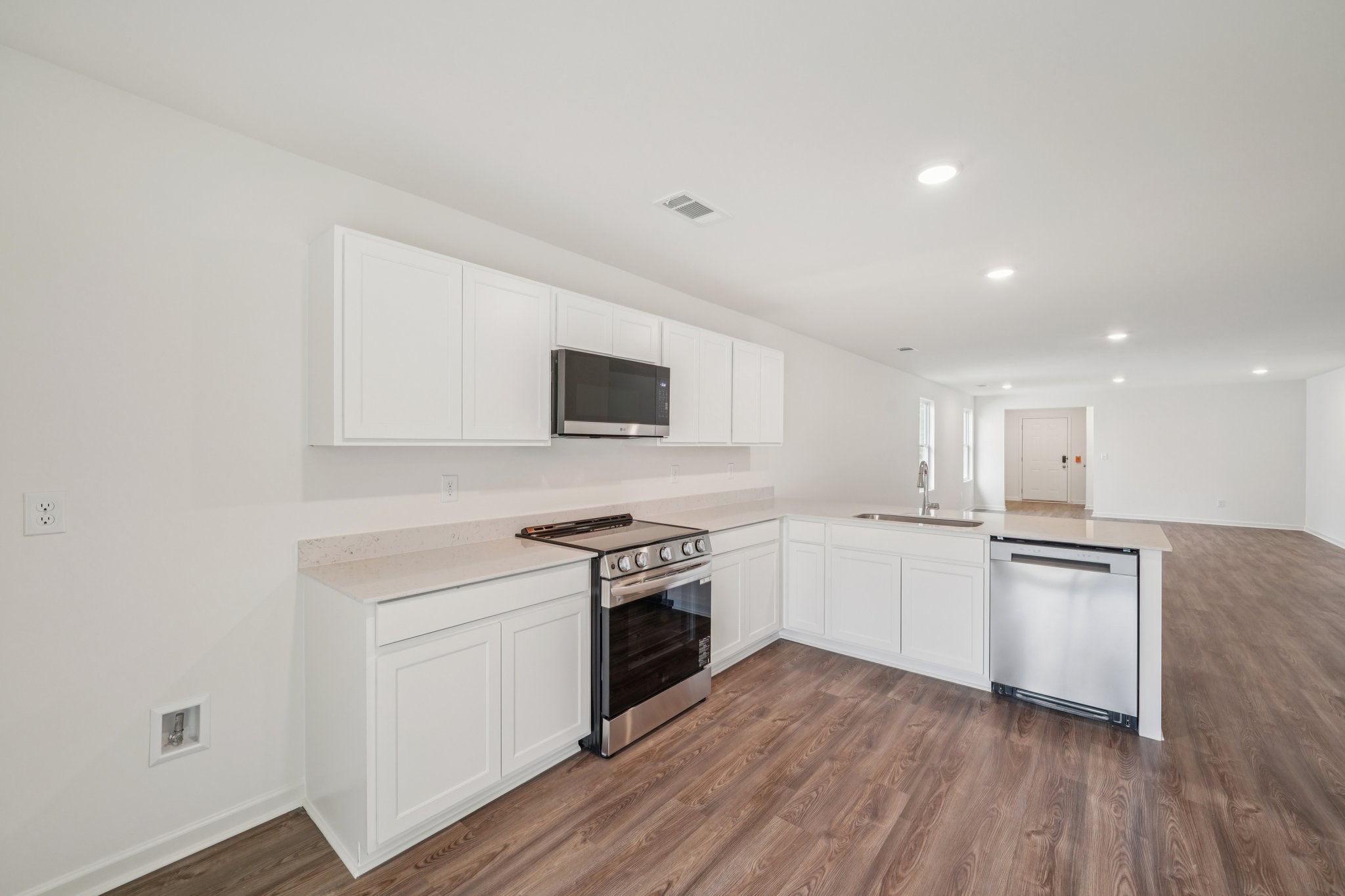 A kitchen with white cabinets.