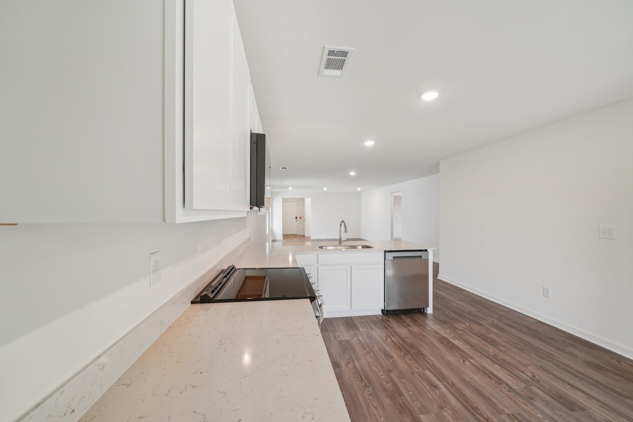 A kitchen with white cabinets.