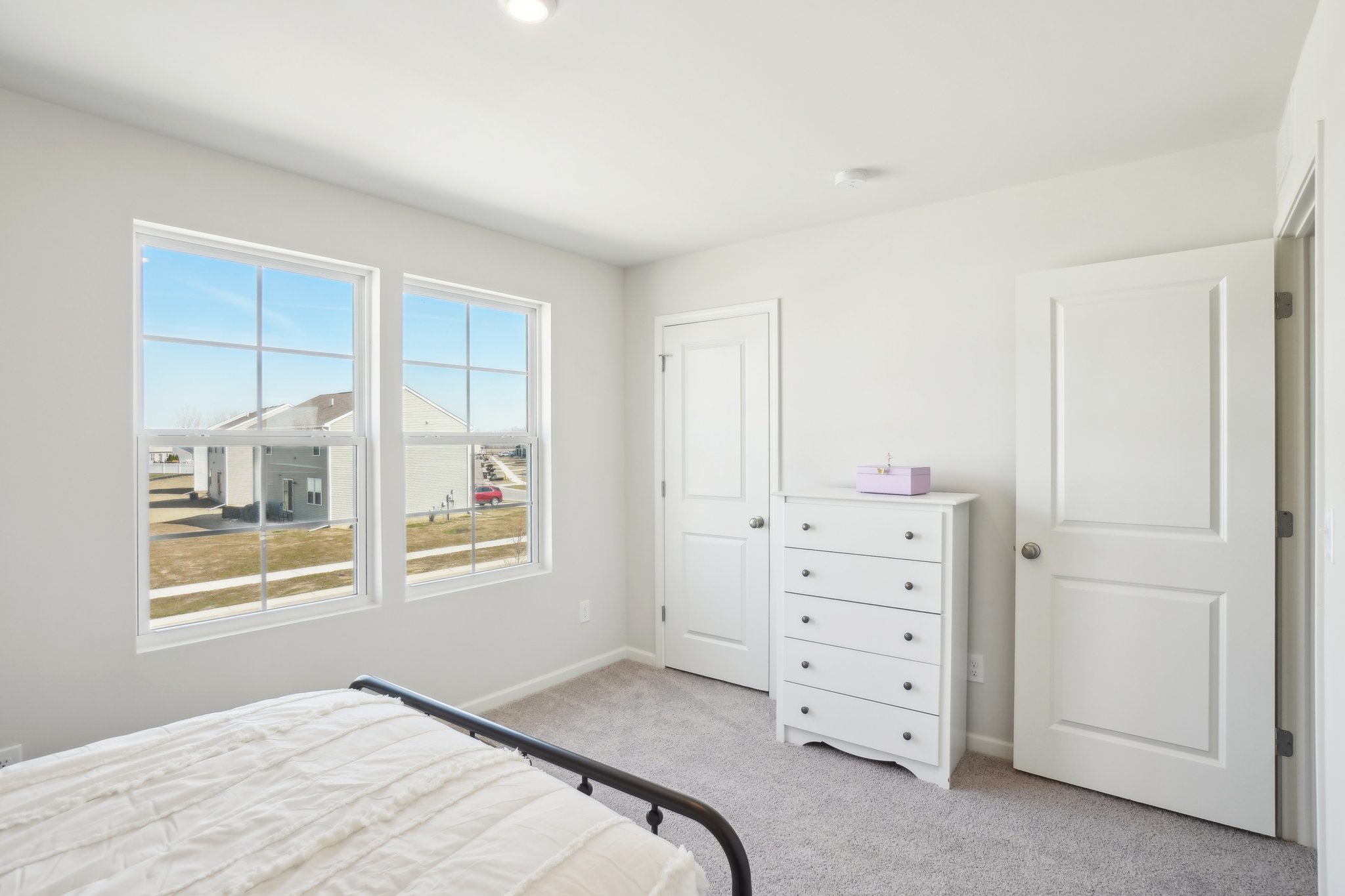 A bedroom with a bed and a window.