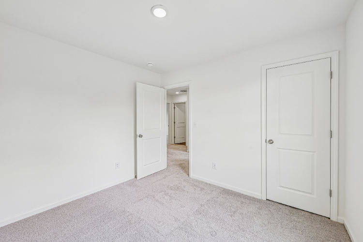 A hallway with white doors.