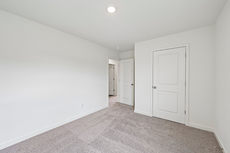 A hallway with white doors.