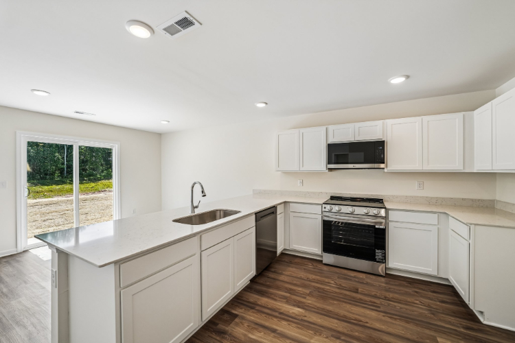 A kitchen with white cabinets.