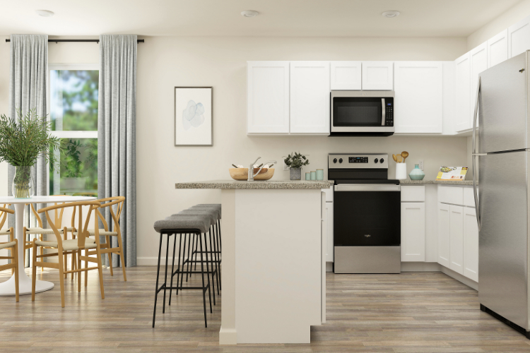 A kitchen with white cabinets.