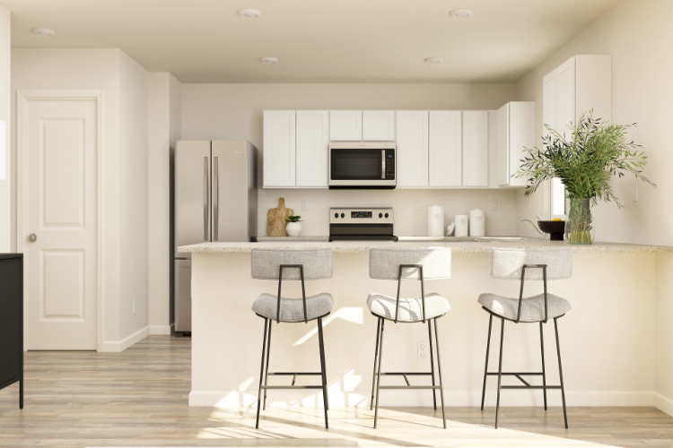 A kitchen with white cabinets.