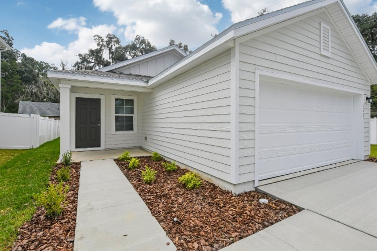 A white house with a driveway.