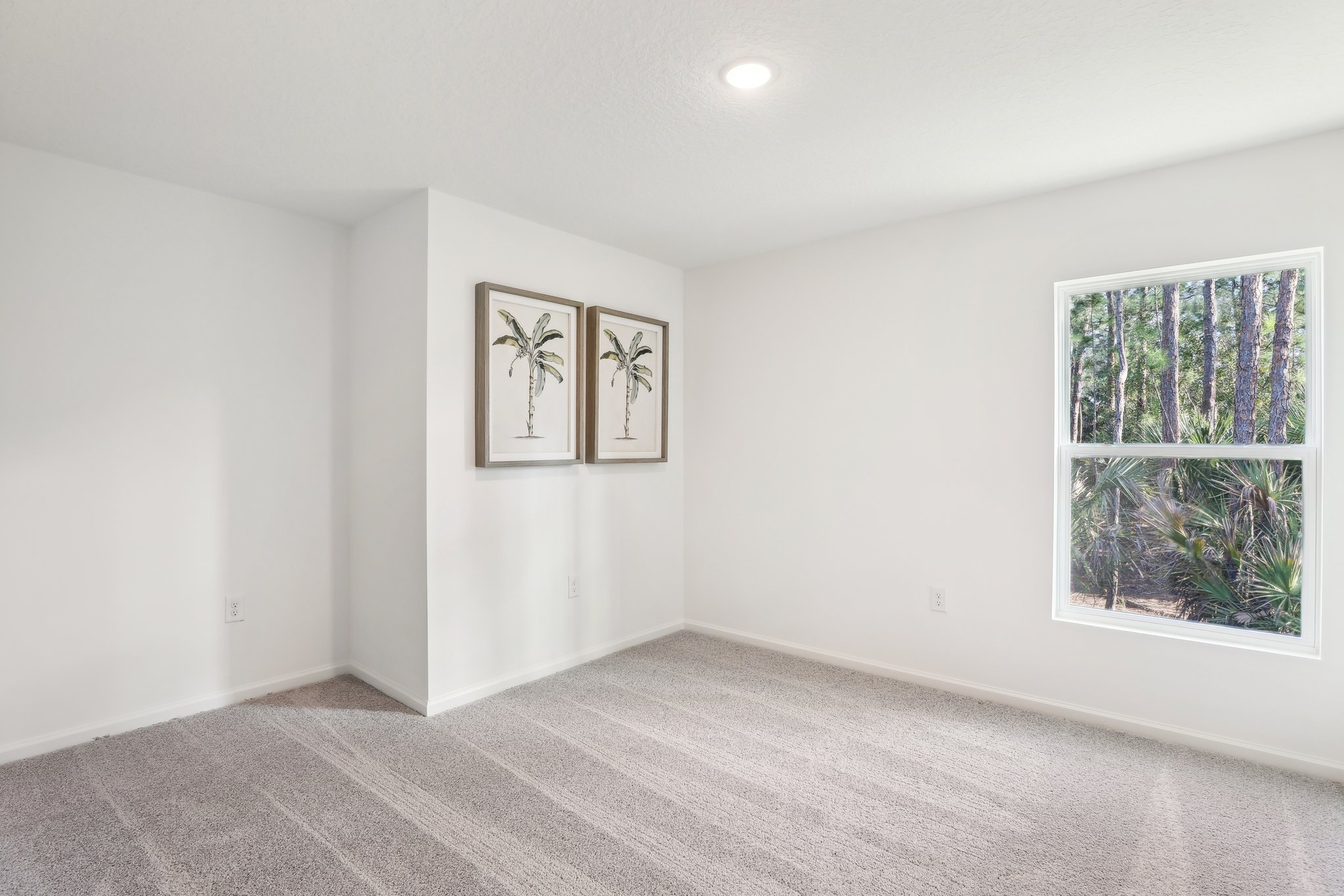 A room with a few paintings on the wall.