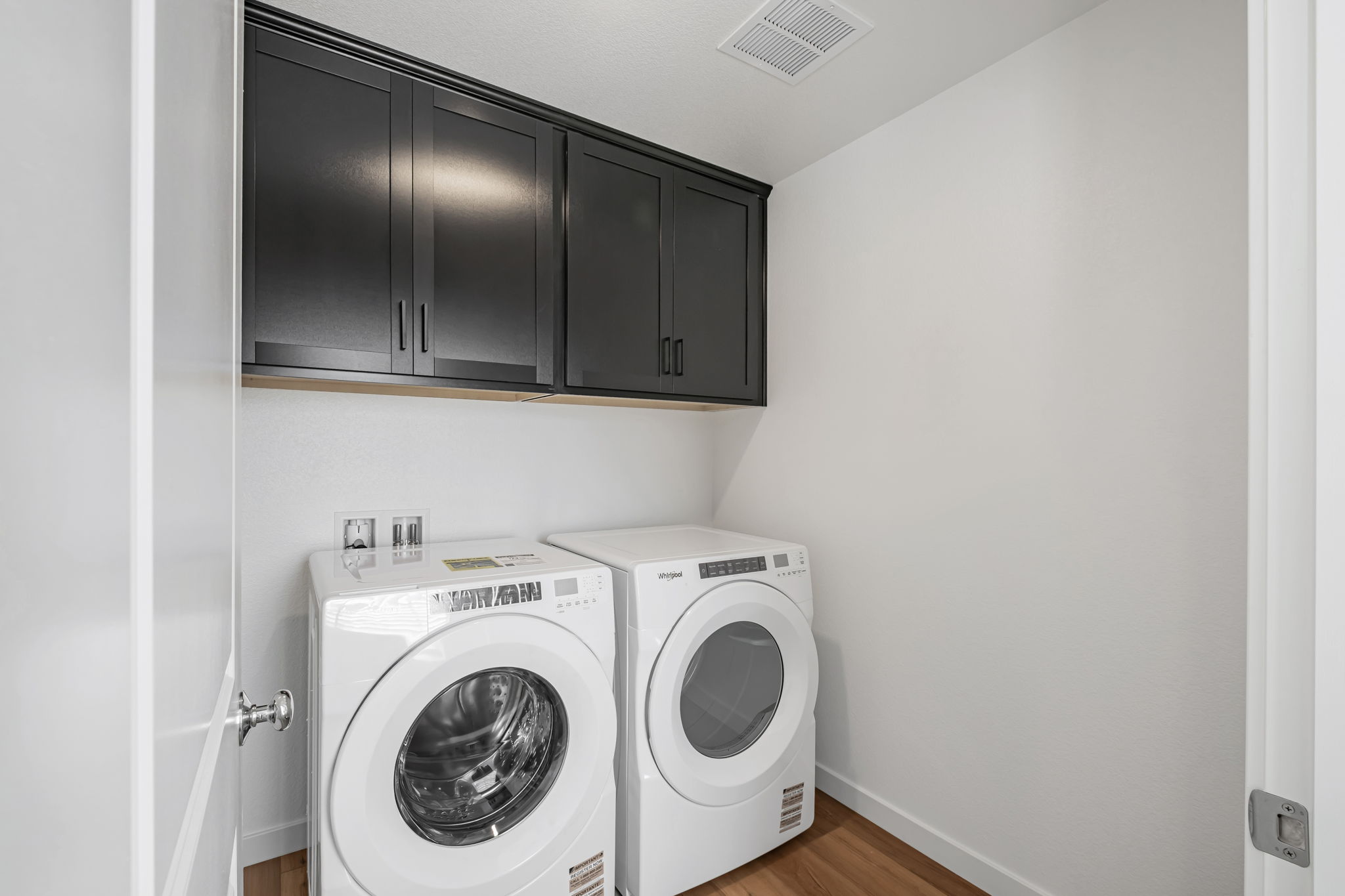 A washing machine and dryer in a room.