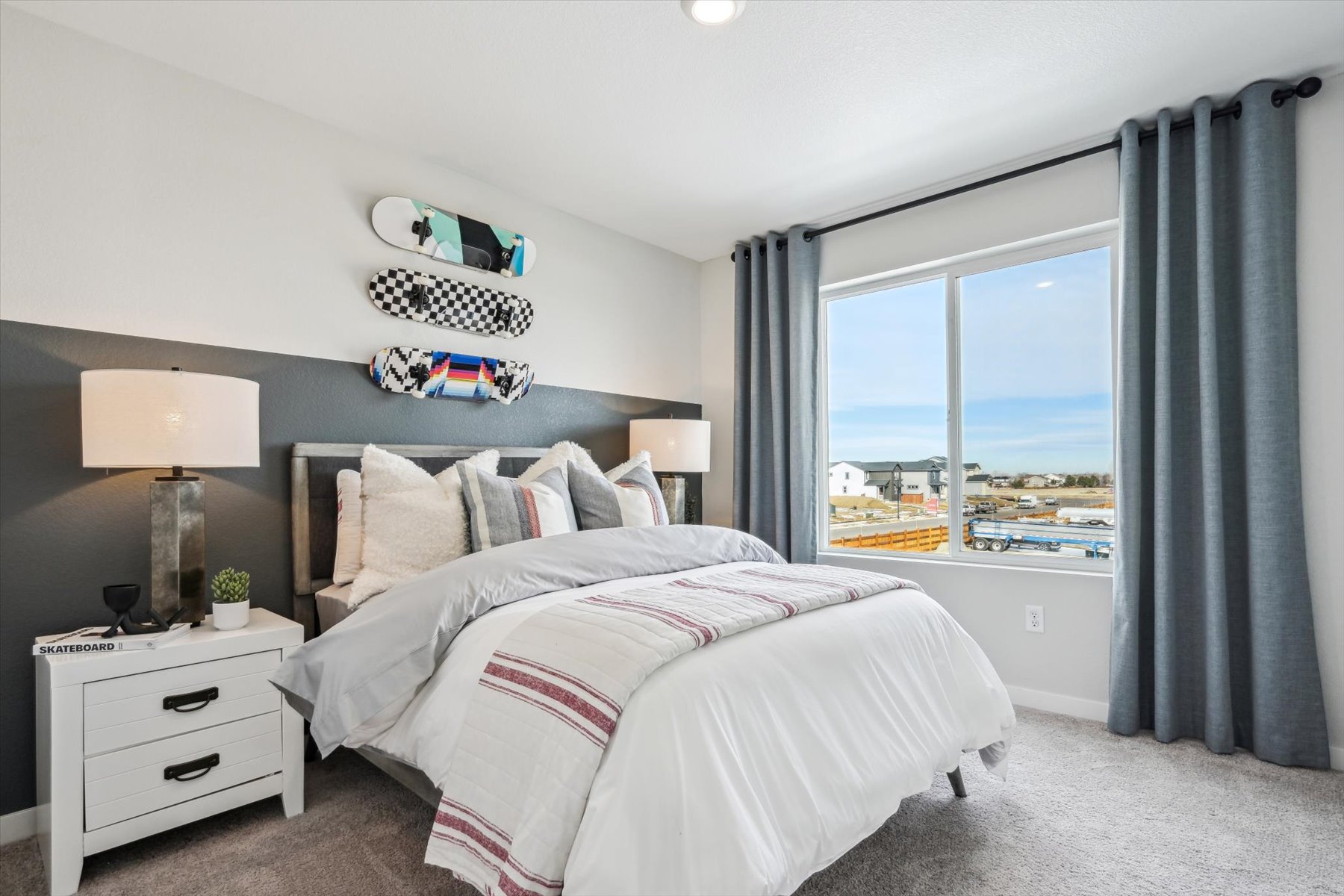 A bedroom with a large window.